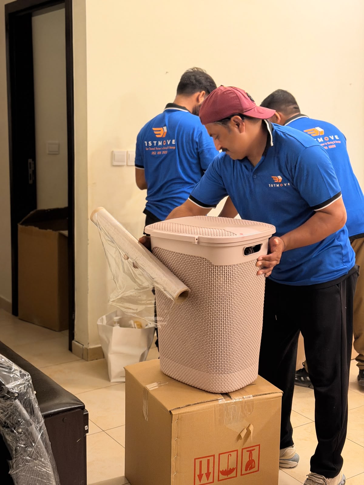 1stMove crew securing boxes and storage baskets during a Dubai move
