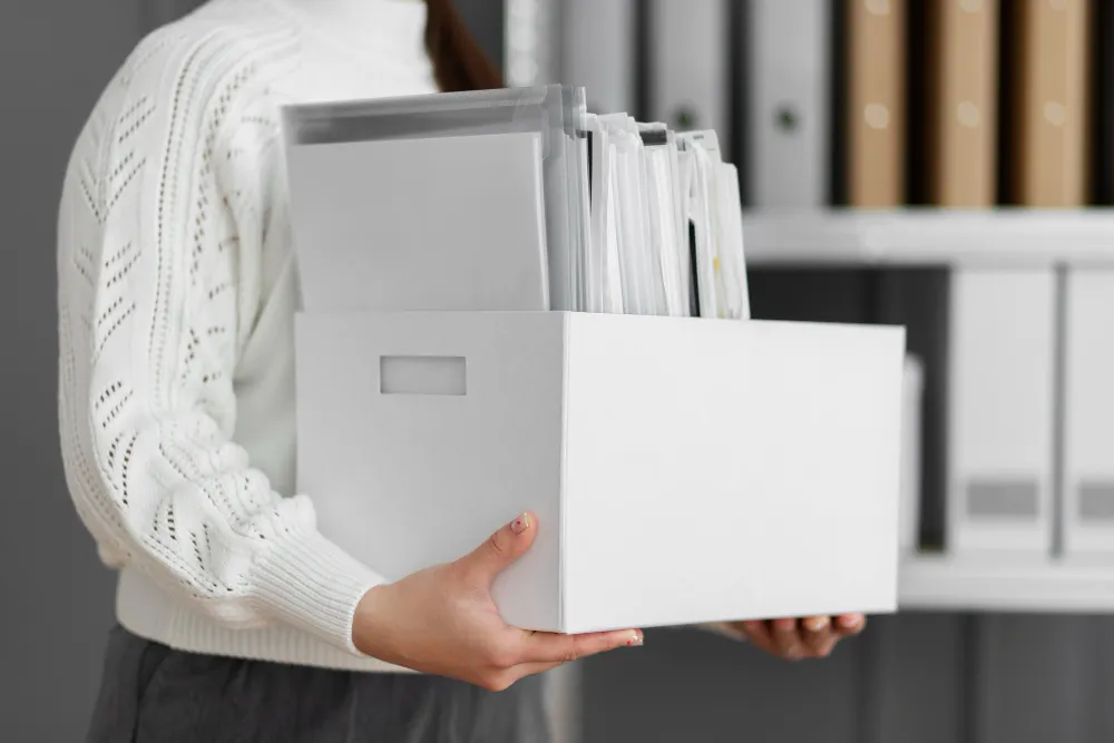 a person holding documents storage box